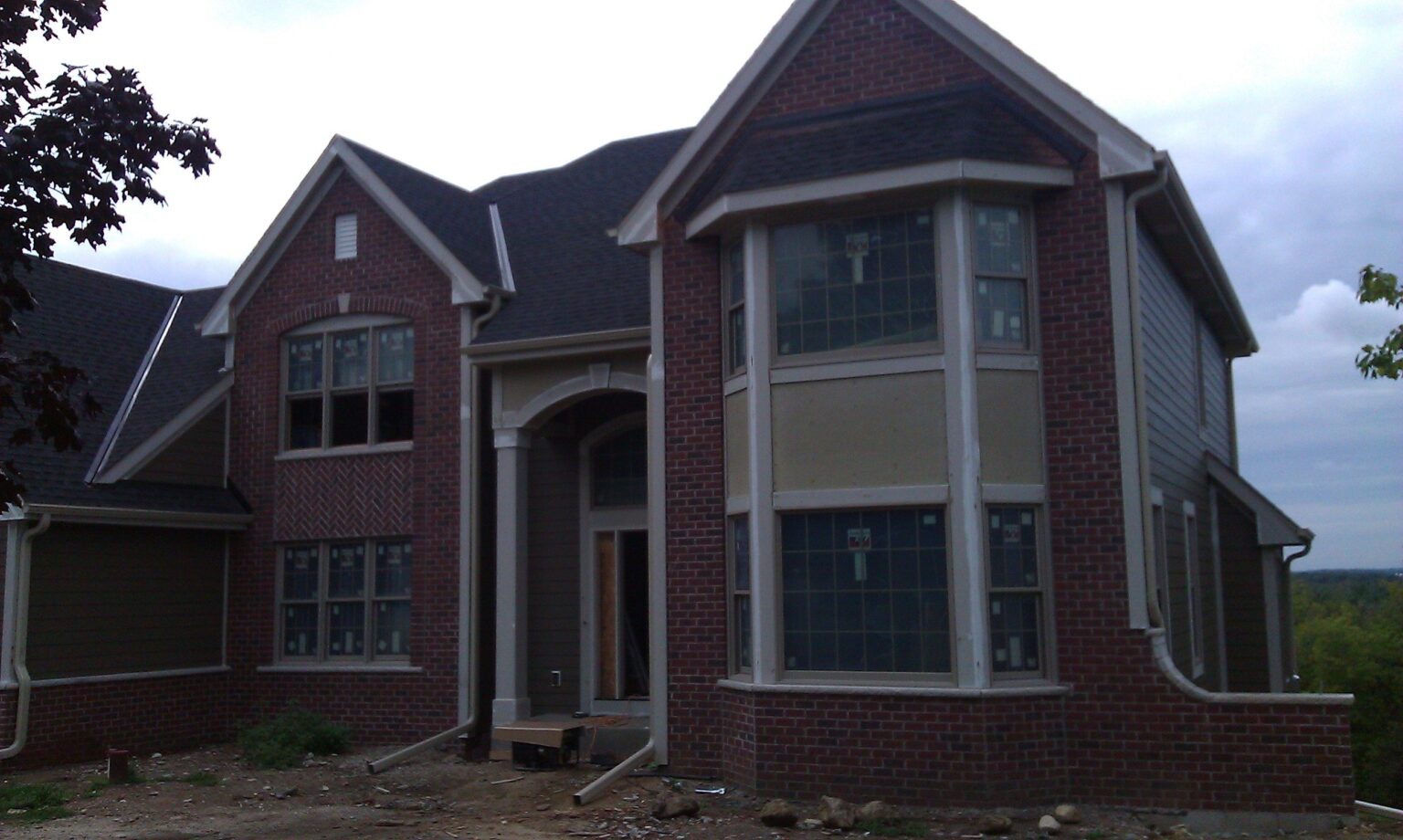 Brick home with gutters and downspouts