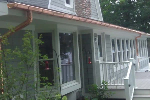 Copper downspout on a porch corner