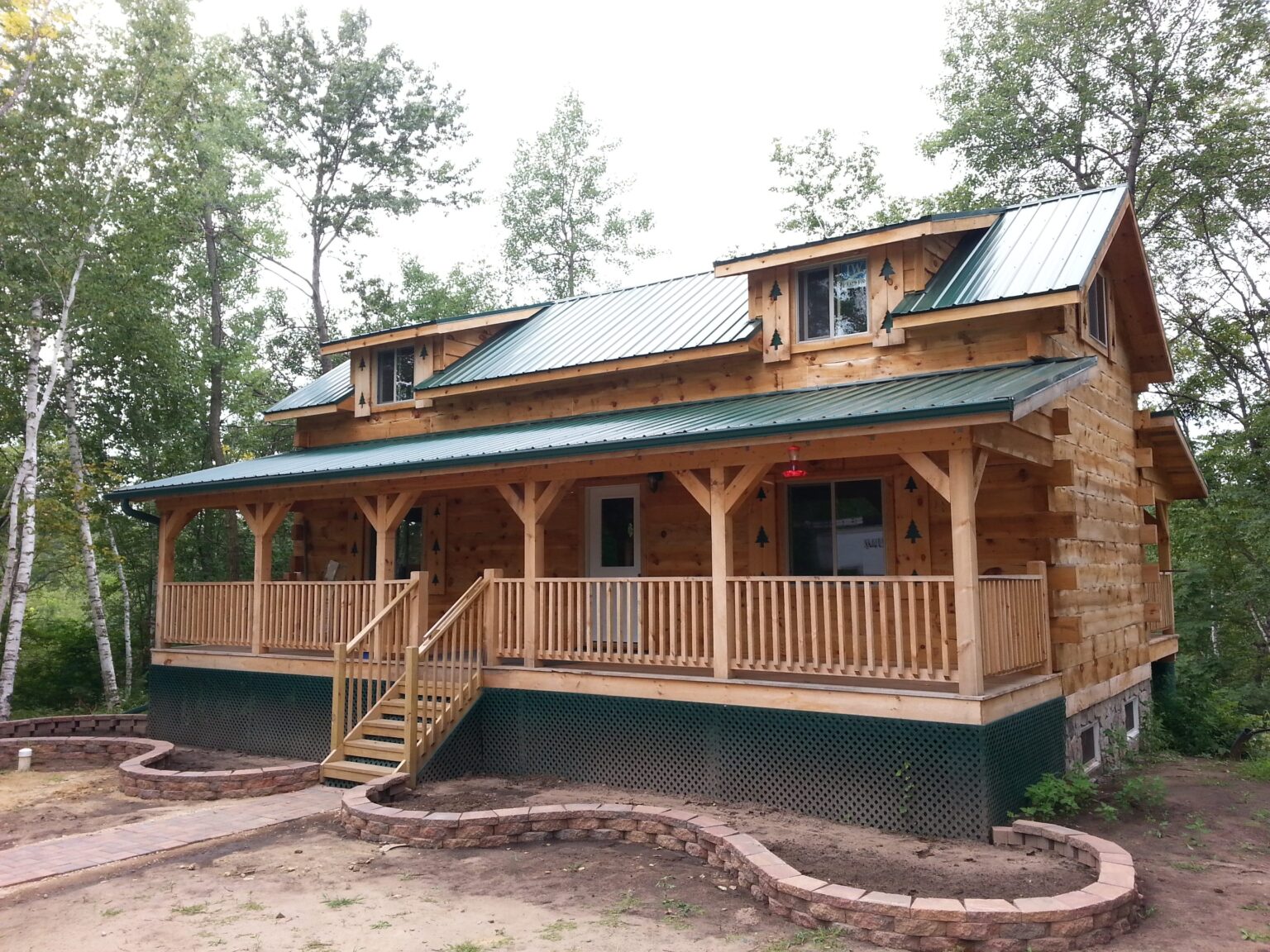 Cabin with a wraparound porch and new gutters